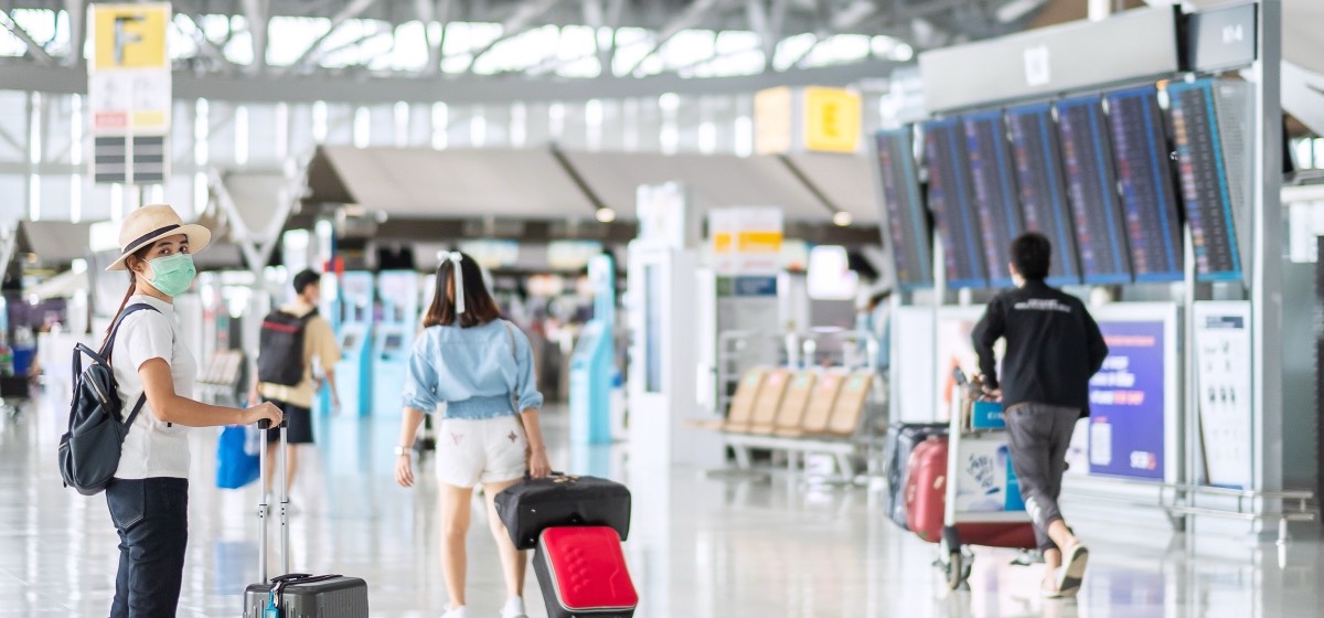 Passengers moving through an airport terminal